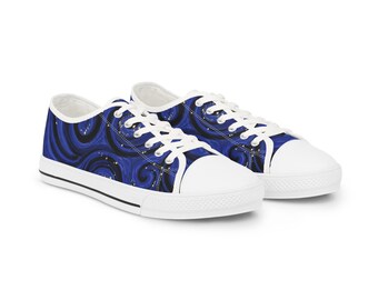 May include: A pair of blue canvas sneakers with a swirling pattern in black and gold. The shoes have white laces, a white toe cap, and a white sole with a black stripe.