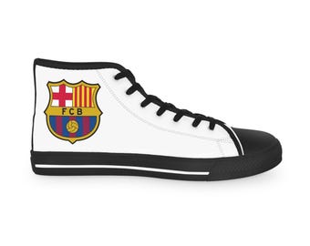 May include: White high-top canvas sneaker with black accents. Features the FC Barcelona team crest on the side. The crest includes a shield with a cross, stripes, and a soccer ball.