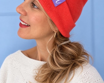 Soft-touch beanie in various colors with a purple "IA" label