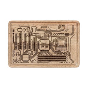 May include: A rectangular wooden chopping board featuring a laser-etched motherboard design. The design includes the text "SNACK PROCESSOR DX4-100" and "MOTHERBOARD V.1.3 1998". The board is light-coloured with a recessed edge.