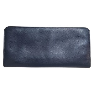 May include: A rectangular, navy blue wallet with a textured surface. The wallet has a zipper closure and a simple, minimalist design. The wallet is made of a durable material.