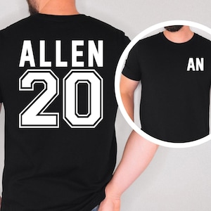 May include: A black short-sleeved t-shirt featuring the name ALLEN and the number 20 in large white block lettering on the back. A circular inset shows the front of the same black t-shirt with the letters AN printed in white on the upper left chest area.