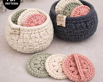 May include: Two round crochet baskets in cream and dark gray, each containing small circular crochet pads in sage green, cream, and dusty pink. A beige tag on each basket reads CRAFTS BY HENLEX. A PDF PATTERN label is visible in the corner.