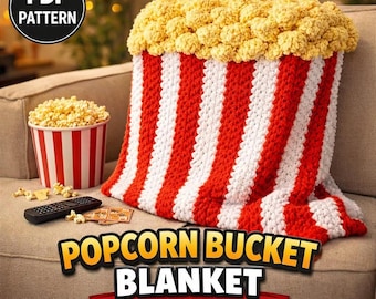 May include: A crochet blanket designed to look like a popcorn bucket with vertical red and white stripes and a textured yellow top resembling popcorn. The image includes a PDF PATTERN label and text reading POPCORN BUCKET BLANKET CROCHET & KNIT PATTERN.