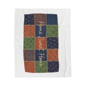 May include: A white ceramic mug with a black handle and the text "But First, Coffee" in a bold, black font. The mug is set against a blurred background, suggesting a cozy setting.