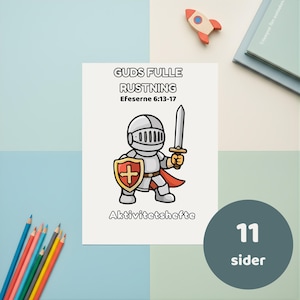 May include: A white activity book cover titled GUDS FULLE RUSTNING Efeserne 6:13-17 and Aktiviteshefte, featuring a cartoon knight in silver armor holding a grey sword and a red and gold shield with a cross, with a small rocket and colored pencils.
