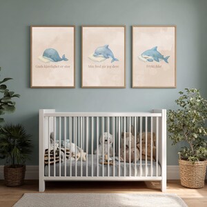 May include: Three framed wall art prints featuring watercolor illustrations of a blue whale, a dolphin, and a shark, each resting on a white pillow. The prints include the Norwegian text Guds kjærlighet er stor, Min fred gir jeg dere, and Frykt ikke.