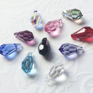 May include: Assortment of ten teardrop-shaped crystal pendants in various colors, including clear, blue, purple, pink, red, and black.