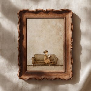 May include: A framed art print featuring a whimsical illustration of a person reading on a sofa. The artwork is set within a decorative, brown wooden frame. The illustration has a warm, neutral color palette, creating a cozy and inviting atmosphere.