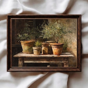 May include: A framed painting depicts potted plants on a rustic wooden table. The artwork features several terracotta pots with green plants, set against a backdrop of warm, earthy tones. The frame is a dark brown color.
