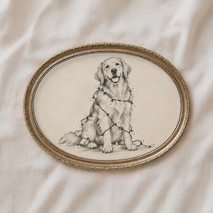 May include: A black and white ink drawing of a golden retriever sitting down, wrapped in a string of holiday lights. The illustration is presented in an oval-shaped, ornate metallic gold frame with a textured, beaded edge detail.