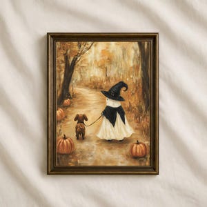 May include: A framed wall art print depicting a ghost wearing a black witch hat and cape, walking a small brown dachshund on a leash through an autumn forest path filled with orange pumpkins and golden brown trees in a soft painterly style.