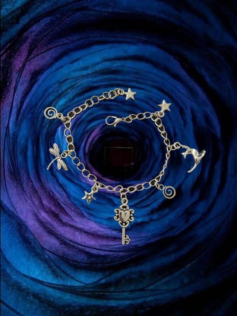 Coraline inspired silver charm bracelet with adjustable length.