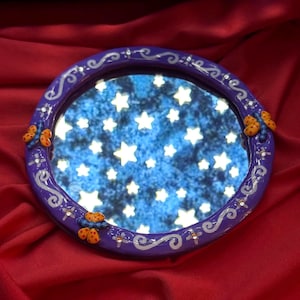 Round Coraline inspired dragonfly mirror with hook on the back to hang on the wall. Made with oven bake clay & cured with resin for shine & protection.