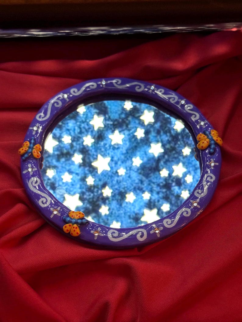 Round Coraline inspired dragonfly mirror with hook on the back to hang on the wall. Made with oven bake clay & cured with resin for shine & protection.