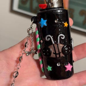 Coraline inspired lighter case with keychain. Made with oven bake clay & cured with resin for shine & protection.