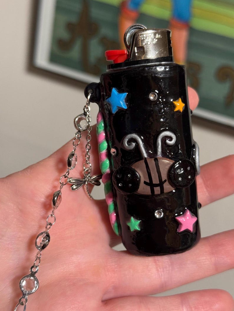 Coraline inspired lighter case with keychain. Made with oven bake clay & cured with resin for shine & protection.
