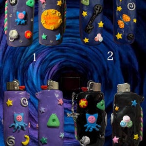 May include: A selection of decorative lighters in shades of purple, blue, and black. Each lighter is decorated with unique embellishments like stars, cartoon characters, and other whimsical designs. The lighters are set against a dark blue backdrop.