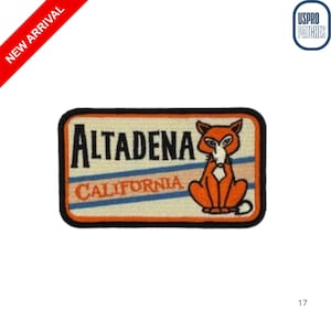 May include: Embroidered patch featuring the word "ALTADENA" above "CALIFORNIA" with a cartoon fox illustration. The patch has a black border, orange fox, and blue and white stripes. The words "NEW ARRIVAL" are on a red banner.