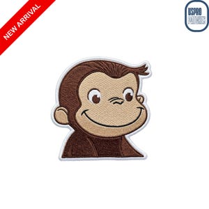 May include: Embroidered patch featuring a smiling cartoon monkey with brown fur and a tan face. The patch has a white border and the text "NEW ARRIVAL" in a red banner. The patch is from USPRO PATCHES.