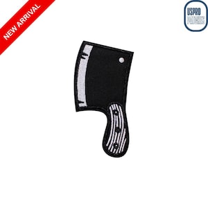 May include: A black cleaver patch with a white stitched blade edge and handle. The handle has a black and white striped design. The patch is on a white background. A red banner in the upper left corner reads "NEW ARRIVAL".