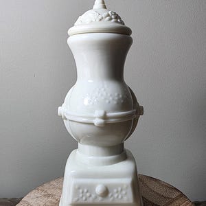 May include: A rustic wooden sign with the text "Welcome to our home" in white lettering. The sign features a distressed finish and a simple, inviting design, perfect for entryway decor.