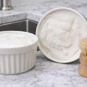 Può includere: Un set di tre tazze in ceramica con finitura opaca e macchiettata. Le tazze sono nei toni del crema, grigio chiaro e grigio scuro. Ogni tazza ha un design semplice e minimalista.