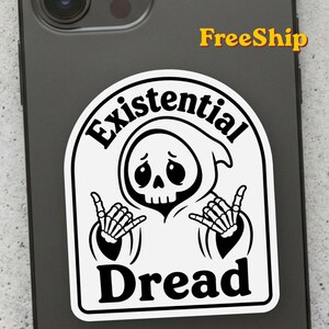 May include: A white sticker with a black border featuring a cartoon grim reaper character with a sad expression making a shaka hand gesture with both skeletal hands. The text Existential Dread is printed in bold black letters above and below.