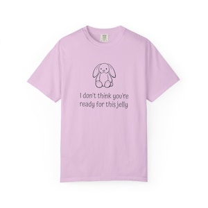 Puede incluir: Camiseta de color lila claro con un dibujo lineal negro de un conejito y el texto "I don't think you're ready for this jelly". La camiseta tiene mangas cortas y cuello redondo.