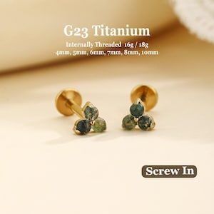 May include: Two G23 titanium internally threaded stud earrings featuring a three-stone cluster design with green moss agate-style beads. The text reads G23 Titanium, Internally Threaded 16g / 18g, 4mm, 5mm, 6mm, 7mm, 8mm, 10mm, and Screw In.