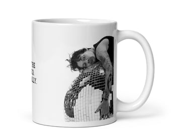 May include: White ceramic mug featuring a black and white image of a person leaning on a disco ball. The mug has a curved handle and the text "THE CO. REALLY." is printed on the side.