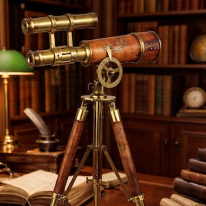 May include: A vintage-style brass and wood telescope on a tripod. The telescope has a brown leather-wrapped barrel and brass fittings. The tripod legs are wood with brass accents. The scene is set in a library with books and antique decor.
