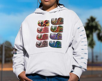 May include: White hoodie with a colorful, patterned design of six hand-like shapes. The design features a variety of colors, including red, yellow, green, and blue. The hoodie has a front pocket and a blue and white design on the sleeve.