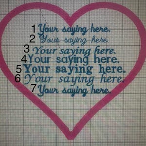 May include: A pink heart outline with the text "Your saying here" repeated seven times in a teal script font. The design is on a grid background, likely for embroidery or a similar craft project.