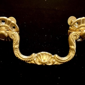 May include: A set of three ceramic mugs with a speckled, matte finish. The mugs are in shades of cream, light brown, and dark brown. Each mug has a simple, minimalist design, perfect for coffee or tea.