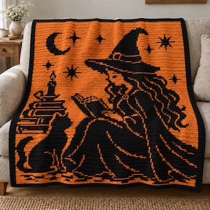 May include: A rectangular crochet blanket featuring a black and orange color scheme. The design displays a witch wearing a pointed hat, reading a book, accompanied by a black cat, a stack of books with a candle, a crescent moon, and stars.