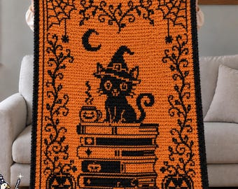 May include: A rectangular crochet blanket featuring a black cat wearing a witch hat, perched on a stack of books with a steaming mug. The design includes a crescent moon, spiderwebs, and jack-o'-lanterns in a black and orange color scheme.
