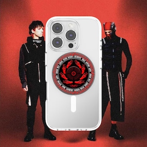 May include: Clear phone case with a red and black circular design. The design features a central pattern surrounded by text. The case is shown against a red background with two people in black outfits.