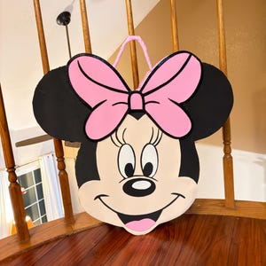 May include: A set of three ceramic nesting bowls in graduating sizes. The bowls feature a speckled, matte finish in shades of cream, light brown, and dark brown. The largest bowl measures approximately 8 inches in diameter.