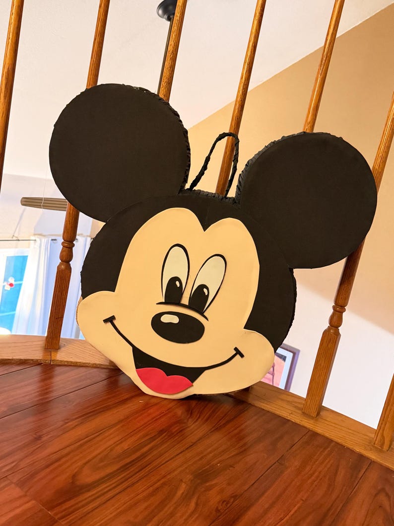 May include: A white ceramic mug with a black handle and the text "But First, Coffee" in a handwritten style. The mug is on a white surface. The mug is 4 inches tall.