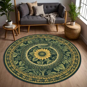 May include: Round area rug with a dark teal background and a detailed design. The rug features a yellow sunflower at the center, surrounded by a snake and botanical elements in shades of green and yellow. The rug is placed on a wooden floor.