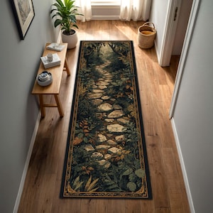 May include: A rectangular hallway rug featuring a pathway design. The rug depicts a stone path winding through a lush forest with green foliage and a dark border with an ornate gold design. The rug is placed on a wooden floor.