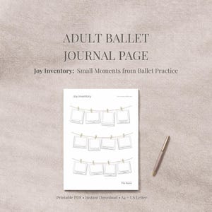 May include: A white journal page with the text "ADULT BALLET JOURNAL PAGE" and "Joy Inventory: Small Moments from Ballet Practice." The page features a design of polaroid-style frames hanging on a string. A pen rests on the right.