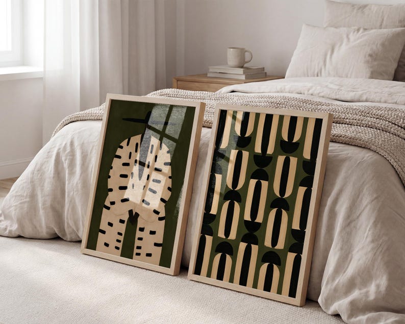 Set of two modern African art prints displayed in natural wood frames, combining a Black male figure with bold geometric pattern artwork.