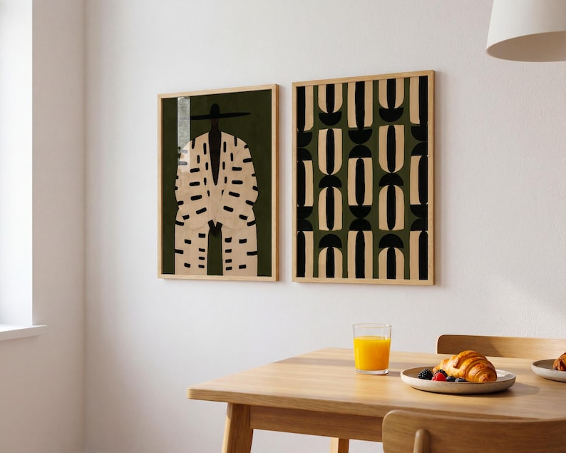 Modern Afrocentric wall art pair displayed above a cream sofa, featuring a Black male portrait and coordinating minimalist pattern.