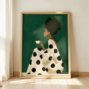 May include: A framed wall art print featuring an illustration of a person with dark curly hair wearing a cream-colored dress with large black polka dots. The person is shown in profile, holding a small white cup against a deep forest green background.