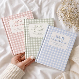 May include: Three hardback books with gingham covers in pink, sage green, and light blue. Each book features a white rectangular label with the text BABY followed by a surname, and the words ADVICE & WISHES FOR SARAH & JAMES printed below.
