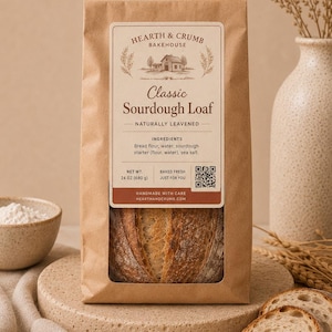 May include: A brown paper bag containing a Classic Sourdough Loaf from Hearth & Crumb Bakehouse. The label lists ingredients as bread flour, water, sourdough starter, and sea salt, with a net weight of 24 oz (680 g) and a QR code.