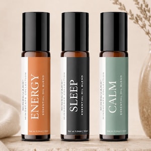 May include: Three essential oil blends from the Mindguard Mindscape Collection. The bottles have black caps and labels with the words "ENERGY", "SLEEP", and "CALM". Each bottle contains 0.34oz (10ml) of essential oil.