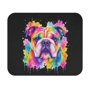 May include: A square black mousepad featuring a colorful watercolor painting of a bulldog. The bulldog's face is painted in a rainbow of colors, with splashes of paint surrounding the dog. The mousepad is a fun and vibrant accessory.